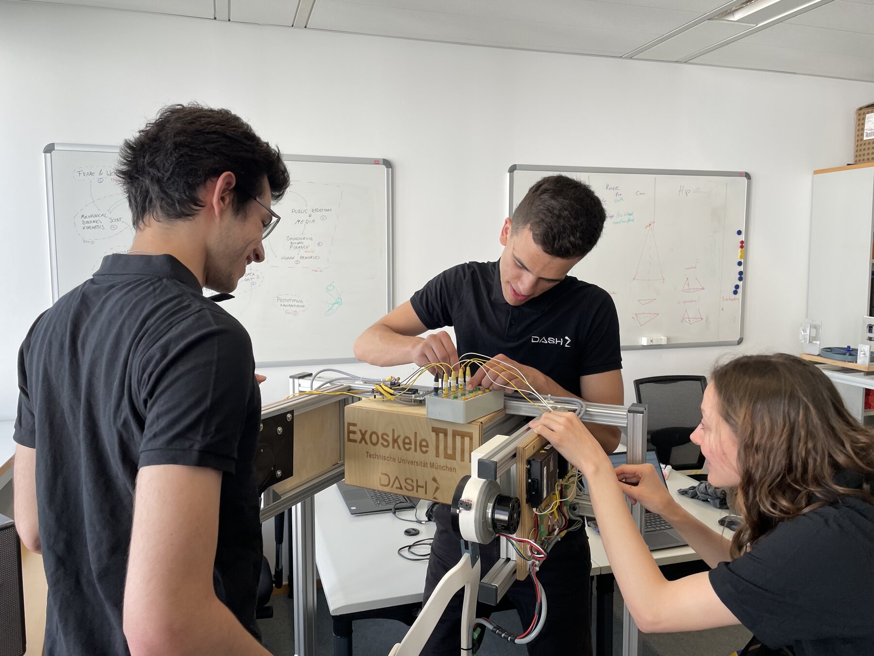 Three DASH members wiring the joint test bench